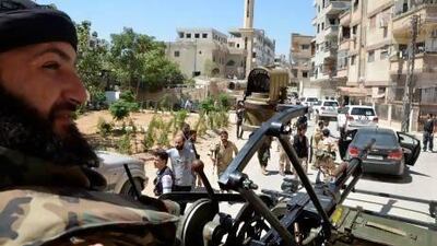 Free Syrian Army fighters escort a convoy of UN vehicles carrying a team of chemical weapons experts during their visit to one of the sites of an alleged chemical weapons attack in the Damascus suburb of Zamalka.