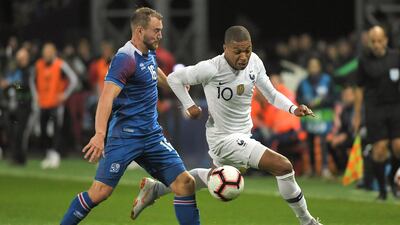 France's forward Kylian Mbappe (R) vies with Iceland's midfielder Runar Mar Sigurjonsson during the friendly football match between France and Iceland at the Roudourou Stadium in Guingamp, western France. AFP