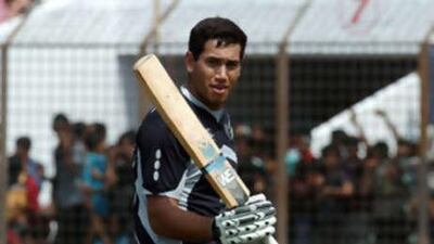The New Zealand batsman Ross Taylor raises his bat after scoring 100 runs during the third One Day International against Bangladesh.
