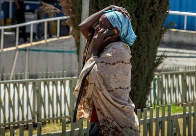 A family member of a victim involved in a plane crash talks on a mobile phone at Addis Ababa international airport. AP