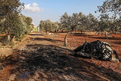 This picture taken on September 20, 2021 shows a view of vehicle destroyed by what is believed to be a drone strike, on the northeastern outskirts of Syria's rebel-held northwestern city of Idlib. AFP