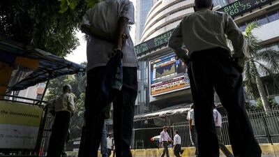 Men look up at an electronic ticker board at the Bombay Stock Exchange (BSE) in Mumbai. Dhiraj Singh / Bloomberg
