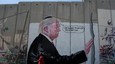 A mural resembling the work of elusive artist Banksy depicting President Donald Trump wearing a Jewish skullcap, is seen on Israel's West Bank separation barrier in the West Bank city of Bethlehem. AP