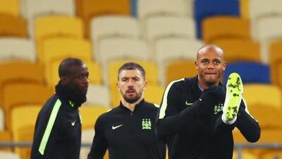 Yaya Toure, Aleksandar Kolarov and Vincent Kompany warm up during a Manchester City training session ahead of their UEFA Champions League round of 16 match against Dynamo Kiev at the Olympic Stadium on February 23, 2016 in Kiev, Ukraine. Michael Steele/Getty Images