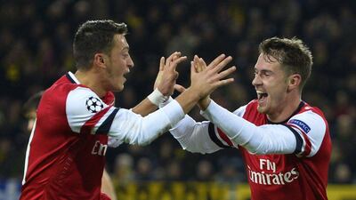 Aaron Ramsey, right, and Mesut Ozil, left, celebrate after Ramsey's goal in a 1-0 win over Borussia Dortmund on Wednesday night. Odd Andersen / AFP