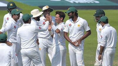 Pakistan spinner Yasir Shah, centre, celebrates a wicket with teammates during the third day of the second Test in Abu Dhabi. Aamir Qureshi / AFP / October 23, 2016