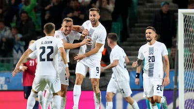 Andraz Sporar celebrates with teammates scoring Slovenia's first goal against Norway. AP