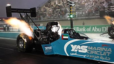 Tommy Johnson Jr, the American driver, in action in his Top Fuel Dragster against fellow American Rod Fuller during the Yas Drag Racing Festival at the Yas Marina circuit, Abu Dhabi yesterday.