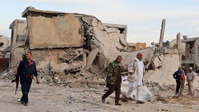 Forces loyal to Libya's UN-backed Government of National Accord walk in the Al Giza Al Bahriya area of Sirte. / AFP