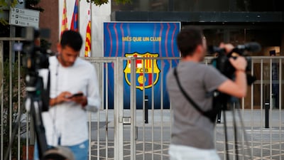 Members of the media outside Barcelona's offices.