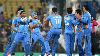 Afghanistan's players celebrate after winning the World T20 cricket tournament match against West Indies at The Vidarbha Cricket Association Stadium in Nagpur on March 27, 2016. Punit Paranjpe / AFP