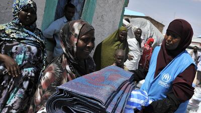 A picture released on June 28, 2011 by the UNHCR and taken on May 31, 2011 shows UNHCR employees distributing blankets and emergency relief items in the Bulo Jawanley settlement of the Galkayo Internally Displaced People (IDP) camp. The United States on J???