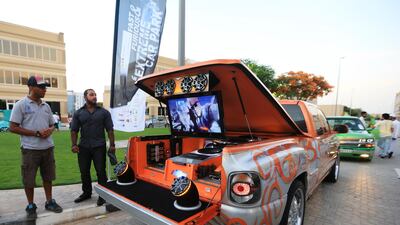 Jassem Al Sumaiti, right, stands with his Chevrolet Silverado.