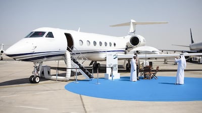 Visitors pose for a photo in front of a Gulfstream G550. Lee Hoagland / The National