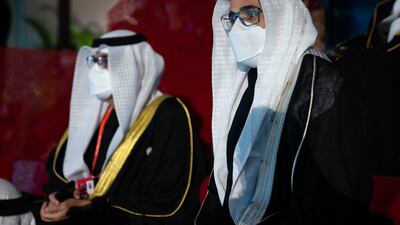 Sheikh Khaled bin Mohamed, Member of the Abu Dhabi Executive Council and Chairman of Abu Dhabi Executive Office, right, attends the opening ceremony of the 2022 Beijing Winter Olympics.