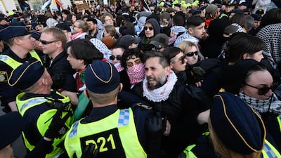 Pro-Palestine protesters face police officers outside Malmo Arena where the 68th Eurovision Song Contest was staged. EPA