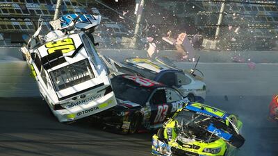 Parker Kligerman, No 30, goes airborne on February 19, 2014, in a crash with Ryan Truex, No 83, Paul Menard, No 27, and Dave Blaney, No 77, during practice for Sunday’s Nascar Daytona 500 Sprint Cup Series race in Daytona Beach, Florida, US. Nigel Cook / AP photo/News-Journal