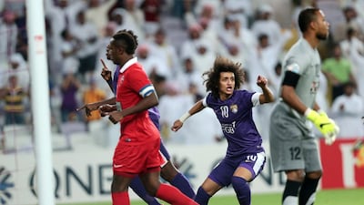 Omar Abdulrahman, centre, wheels away in celebration after Asamoah Gyan's opening goal. The game would eventually be drawn 3-3 to send Al Ahli through. Christopher Pike / The National