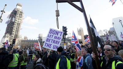 Demonstrators hold placards and flags at a pro-Brexit rally in London. AP