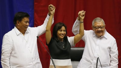 Congresswoman Leni Robredo is proclaimed Philippine vice-president elect by senate president Franklin Drilon, left, and house speaker Feliciano Belmonte during a ceremony on May 30, 2016. President-elect Rodrigo Duterte did not show up for the proclamation ceremony. Bullit Marquez/AP Photo