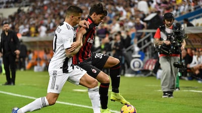 AC Milan's Brazilian midfielder Lucas Paqueta, right, is challenged by Joao Cancelo. AFP