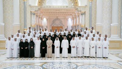 Sheikh Mohammed bin Rashid and Sheikh Mohamed bin Zayed stand for a photograph after signing a piece of the Hope Probe. Seen with Dr Ahmed Belhoul Al Falasi, Minister of State for Higher Education; Sheikh Saif bin Zayed; Sheikh Mansour bin Zayed; Sarah Al Amiri; and Sheikh Abdullah bin Zayed. Hamad Al Kaabi / Ministry of Presidential Affairs