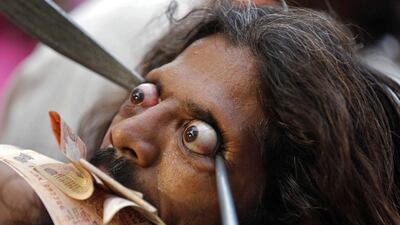 A Muslim pilgrim holds his eyes open as he performs inside the shrine of Muslim saint Shah-e-Alam during Urs, in the western Indian city of Ahmedabad. Urs is an annual festival held for 10 days to mark the death anniversary of the Muslim saint in the city. Amit Dave / Reuters