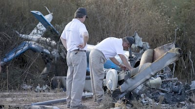 Argentine civil aviation accident investigators inspect the wreckage of one of two helicopters that collided in midair, near Villa Castelli, in Argentina's La Rioja province on Tuesday. They will be joined by their French counterparts on Wednesday. Natacha Pisarenko / AP Photo