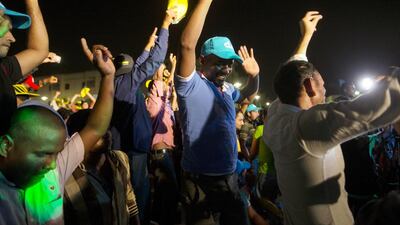 Workers dance while watching the finals. Christopher Pike / The National