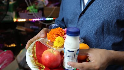 People bring plates with food and flowers to the Shiva Temple during Diwali in Bur Dubai on Saturday, October 26, 2019. Chris Whiteoak / The National