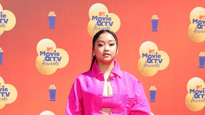 Lana Condor wearing a co-ordinated hot pink Valentino suit and crop top. AFP