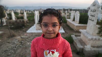 Syrian earthquake survivor Yasmine Al Sham in the cemetery of Jindayris, in Aleppo province. Save the Children says many young survivors are 'struggling to process everything they have endured'. AFP