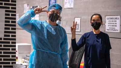 Health workers keep the mood cheery for young pupils getting tested.