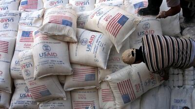 Palestinians unload bags of flour donated by the United States Agency for International Development, USAID, at a depot in the West Bank village of Anin near Jenin. AP, File