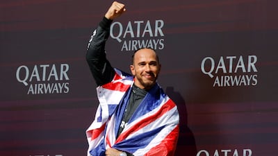 Mercedes' Lewis Hamilton celebrates on the podium after winning the British Grand Prix at Silverstone on July 7, 2024. Reuters