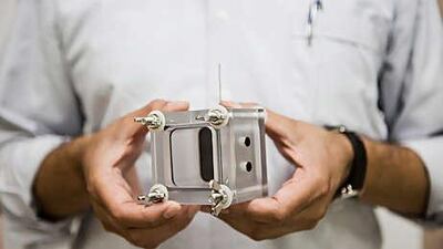 Dr Farrukh Ahmad holds a microbial fuel cell, which is being used to treat waste water.