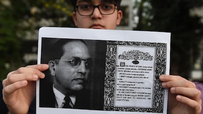 A student holding a placard as he participates in a protest against India's new citizenship law outside the Gandhi Ashram in Ahmedabad. AFP