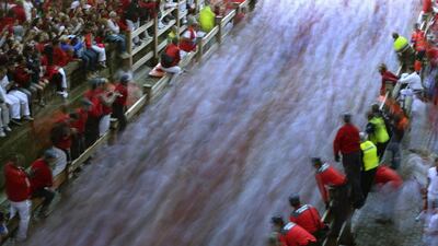 Runners enter the bullring during the second running of the bulls of the San Fermin festival in Pamplona. Two runners were hospitalised following a run that lasted two minutes and twenty seconds, according to local media. Vincent West / Reuters