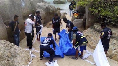 Thai forensic workers wrap the bodies of two British tourists found dead on a beach of Koh Tao island, Surat Thani province, southern Thailand, 15 September 2014. EPA