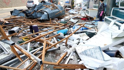 A woman looks at debris caused by Typhoon Maysak in Pohang, South Korea. Reuters