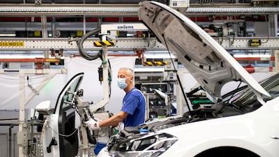 A worker wears a protective mask on the Volkswagen assembly line. Reuters