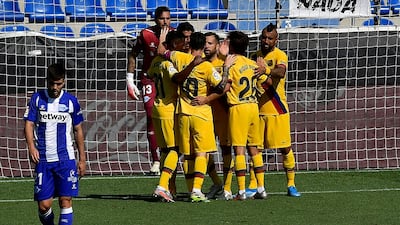 Barcelona players celebrate a goal from Luis Suarez against Alaves. AP Photo