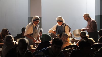 Nuns distribute food for poor people at Mother's House in Kolkata, India. EPA