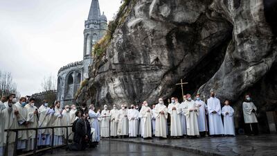 Priests attend the reopening of the cave at Massabielle in the Sanctuary of Our Lady of Lourdes in Lourdes, south-west France after almost two years, as Covid-19 restrictions are eased. AFP