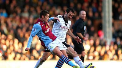 Ashley Westwood, left, of Aston Villa passes the ball under pressure from Giorgos Karagounis of Fulham during their match on Sunday afternoon. Paul Gilham / Getty Images