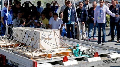 In this February 16, 2018 photo, government officials and siblings of Joanna Demafelis look at the wooden casket of her remains at the Ninoy Aquino International Airport in suburban Pasay city, southeast of Manila, Philippines. Bullit Marquez / AP