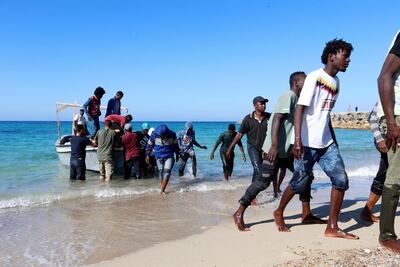 Migrants rescued by the Libyan coastguard come ashore in Tripoli on July 26, 2019. Reuters