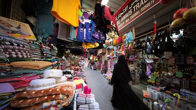 A Bahraini woman walks through local souq as she looks for clothes for her children ahead of Eid al-Adha in Manama, Bahrain, August 19, 2018. REUTERS/Hamad I Mohammed