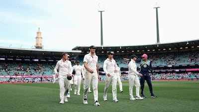 Australian players led by Pat Cummins leave the field. Getty Images