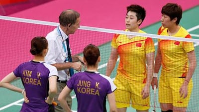 An official speaks to players from China and South Korea during their controversial women's doubles match at London 2012